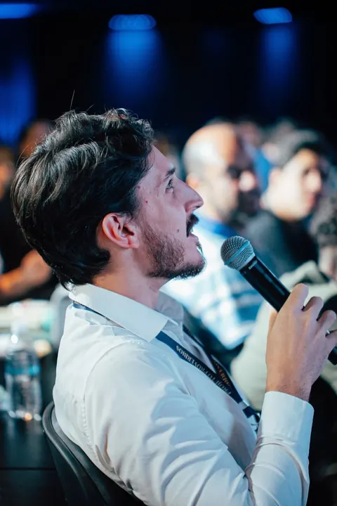 Participante fazendo uma pergunta ao microfone